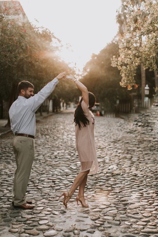The engaged couple toasting with champagne on top of a Charleston parking garage