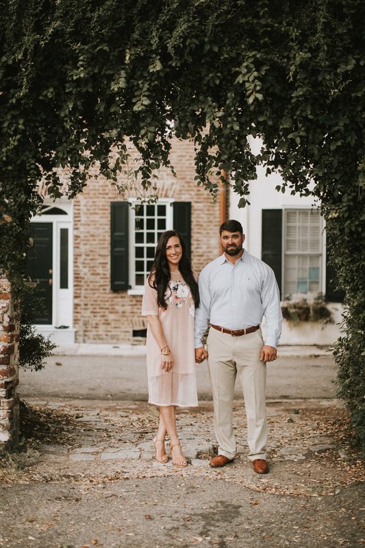 The family walking down a brick alley on top of a Charleston parking garage