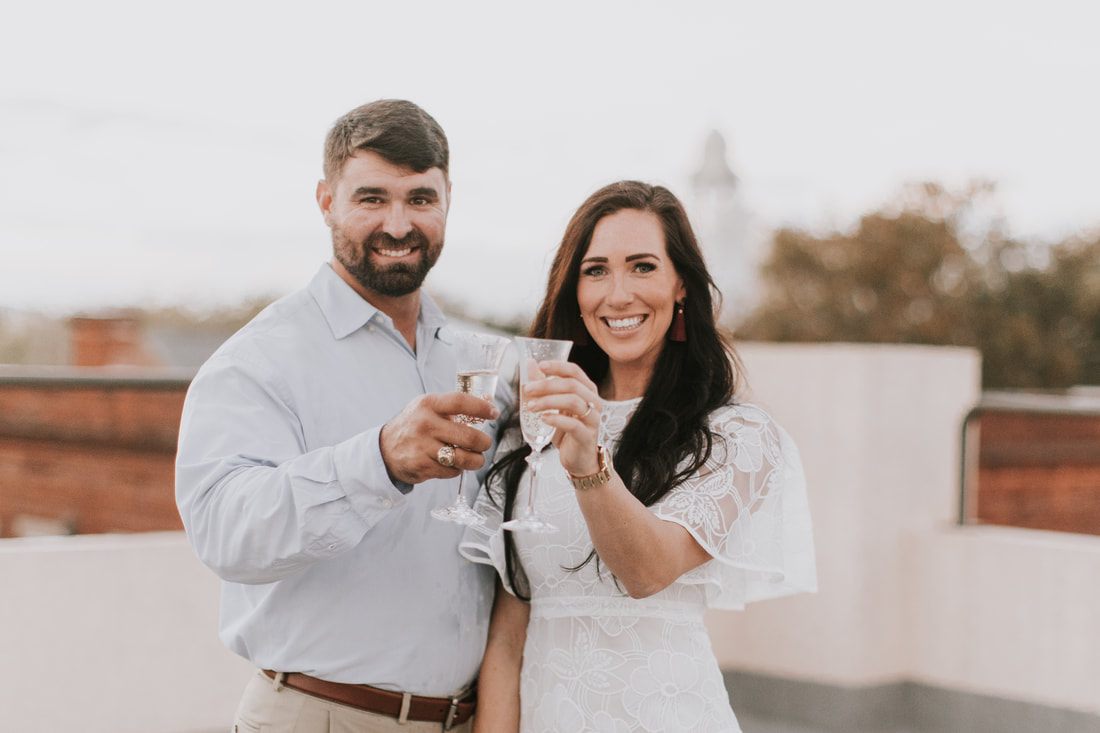The engaged couple dancing together near an abandoned lot downtown