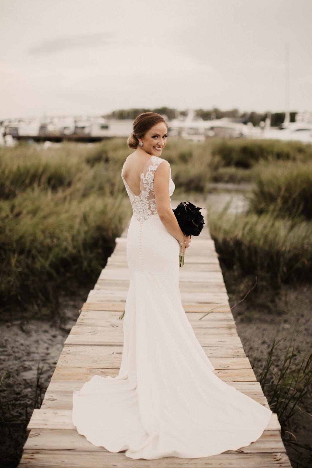 The bride and groom embracing during their first look at Colonial Lake
