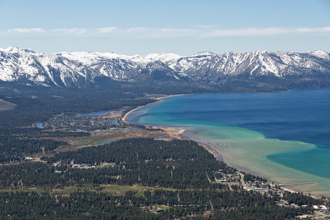 Blue water and pine forest along South Lake Tahoe, California