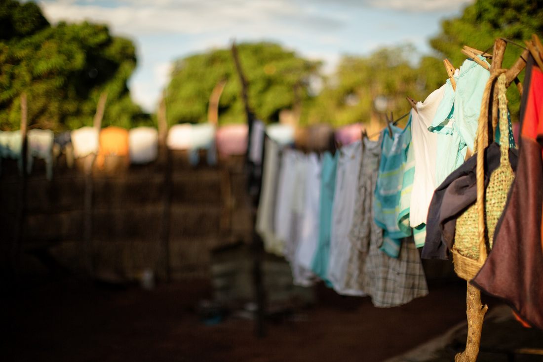 Craft vendor arranging goods for sale in Chief Mukuni Village