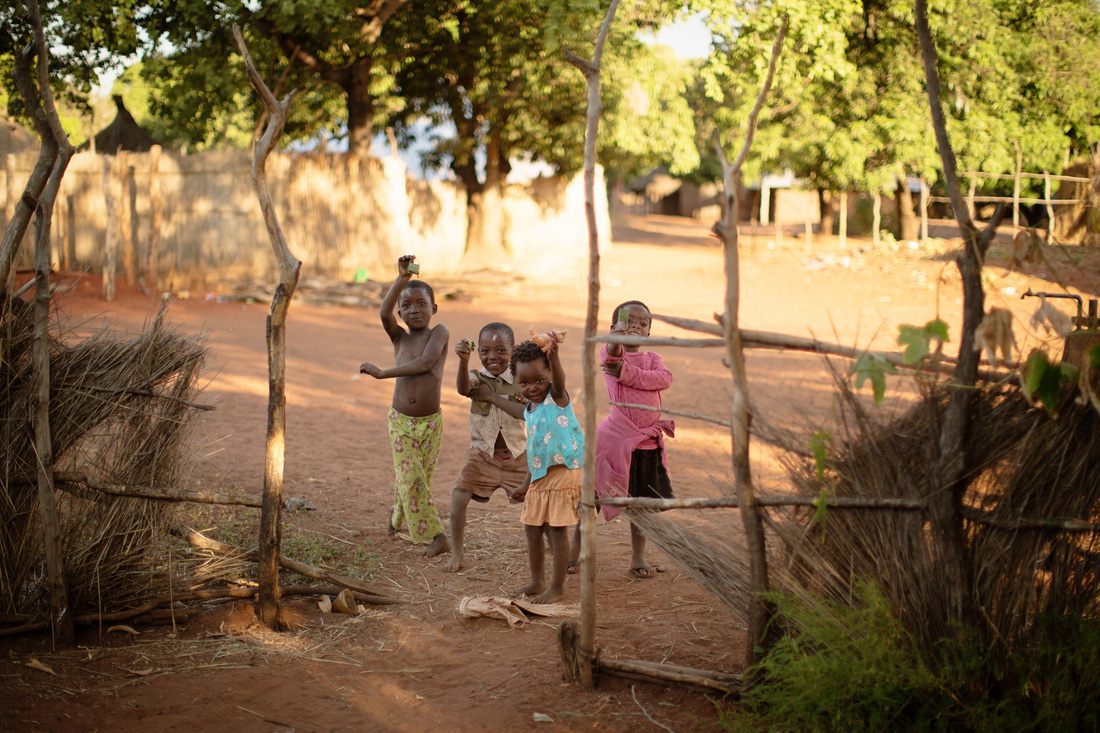 A village pathway winding between huts in Chief Mukuni Village