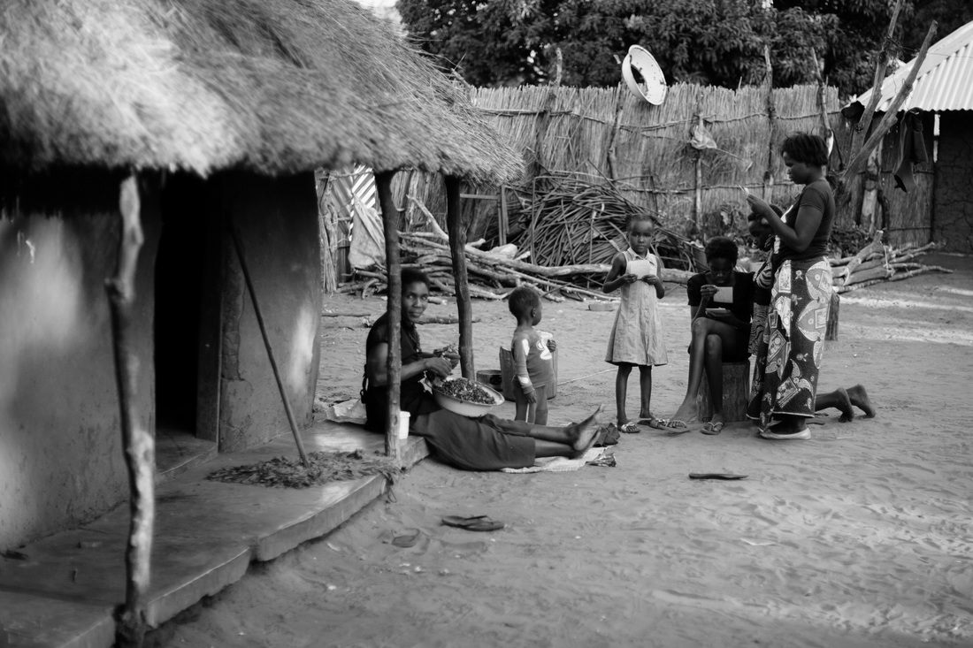 Local woman carrying goods through Chief Mukuni Village, Zambia