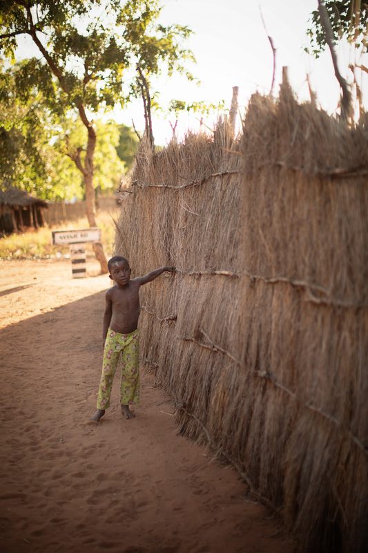 Wood smoke rising from a cooking hut in Chief Mukuni Village