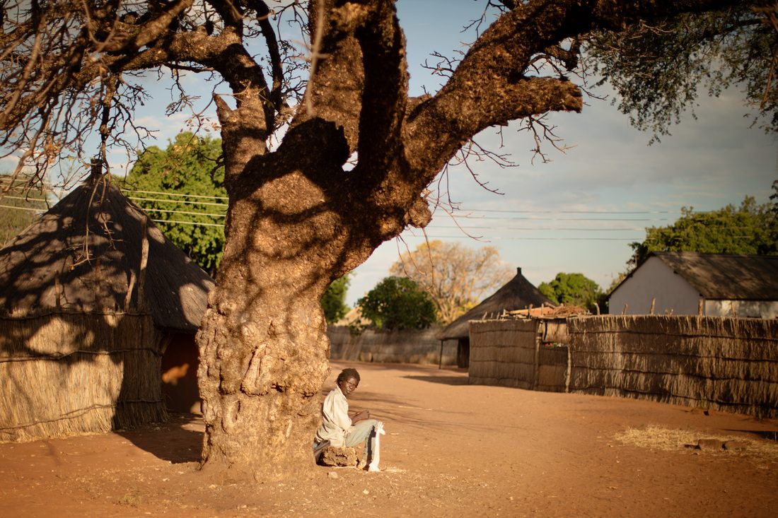 A woman preparing food outside a cooking hut in Chief Mukuni Village