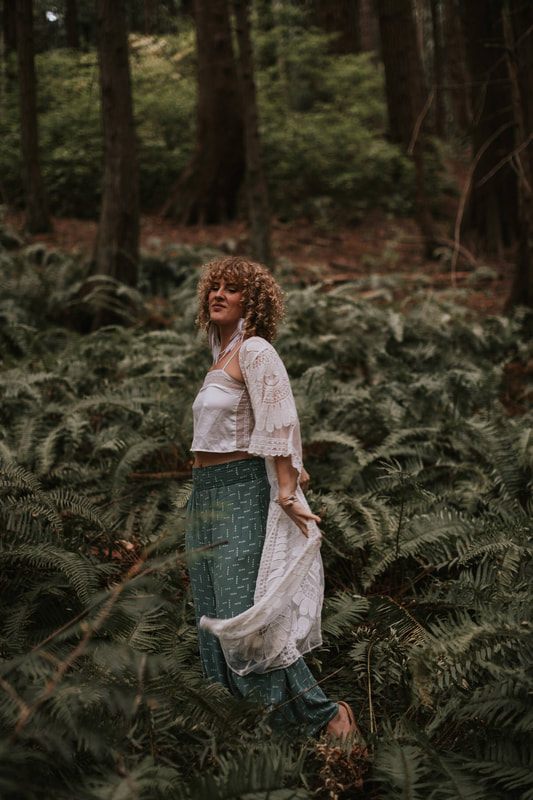 Savannah and Amanda standing together on a nature trail during their branding photoshoot