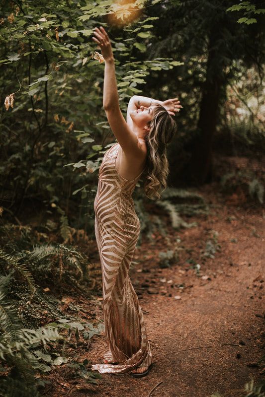 Savannah and Amanda posing together surrounded by dense forest