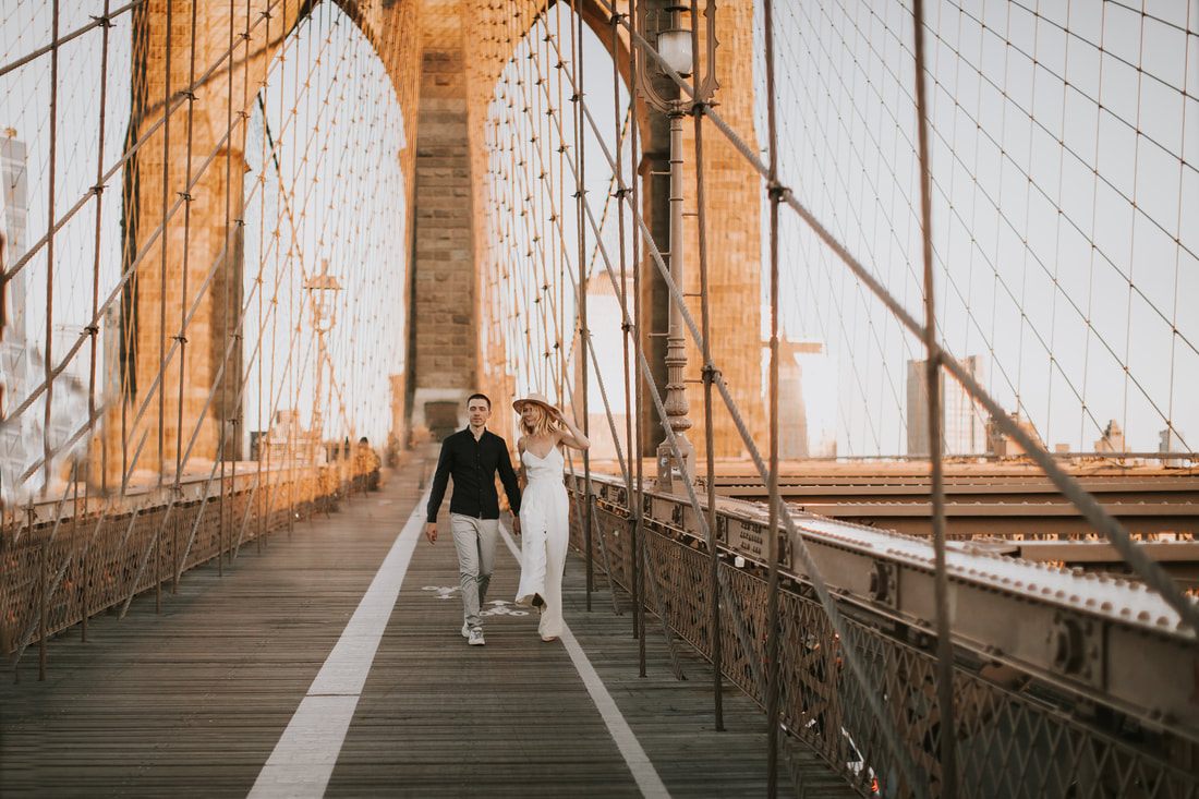 Valentina and Alex watching the sunrise together on the Brooklyn Bridge