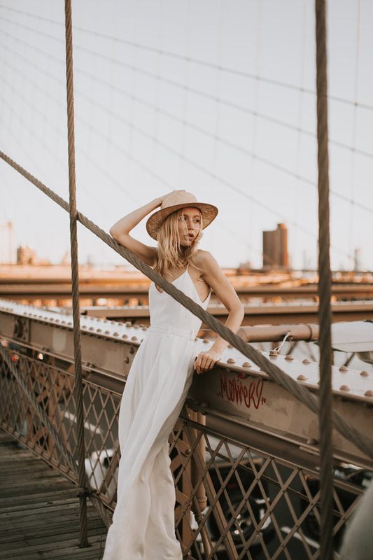 Valentina in her Schone Bride romper walking with Alex through Brooklyn