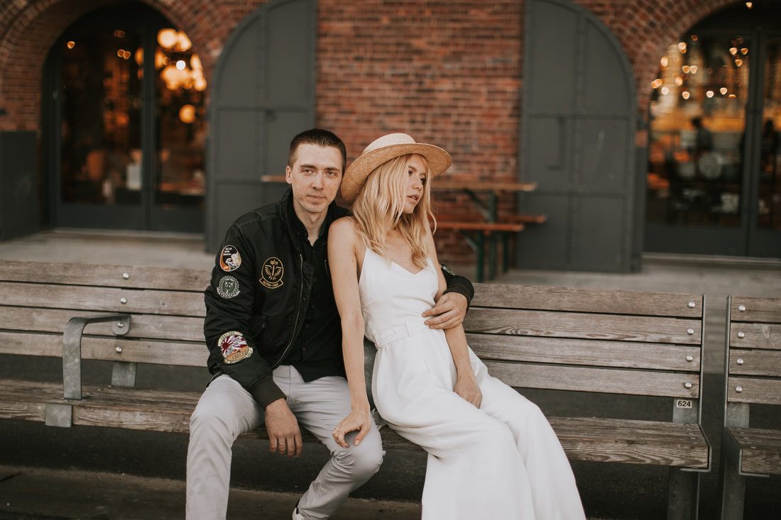 Valentina and Alex sharing a quiet moment against a Brooklyn brick wall