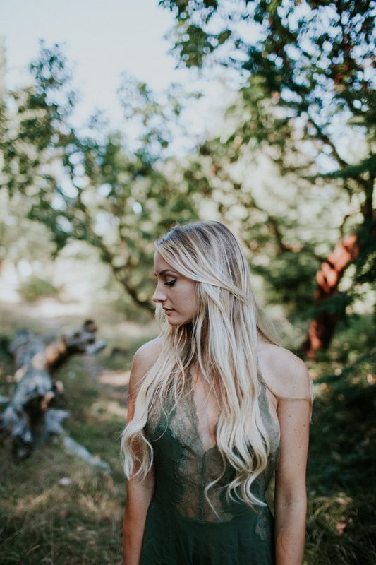 Model wearing Free People clothing in a lush PNW forest setting