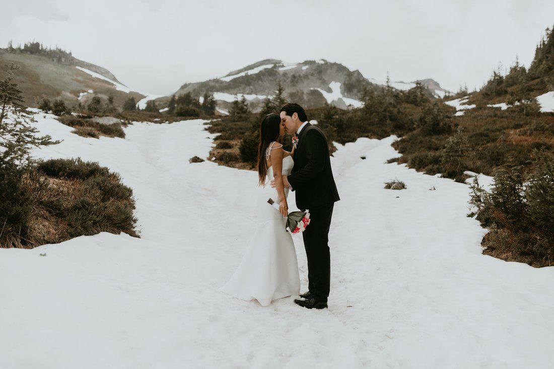 Couple sharing a quiet moment together during their Mt. Rainier vow renewal ceremony.