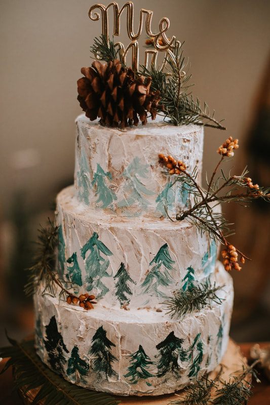 Newlyweds cutting their small reception cake at the cabin