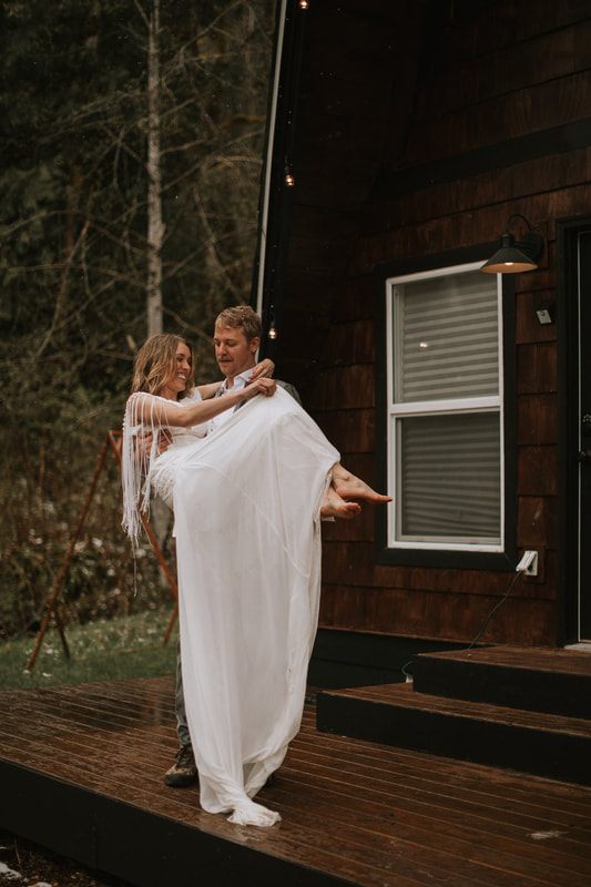 Couple walking away from the cabin hand in hand at dusk