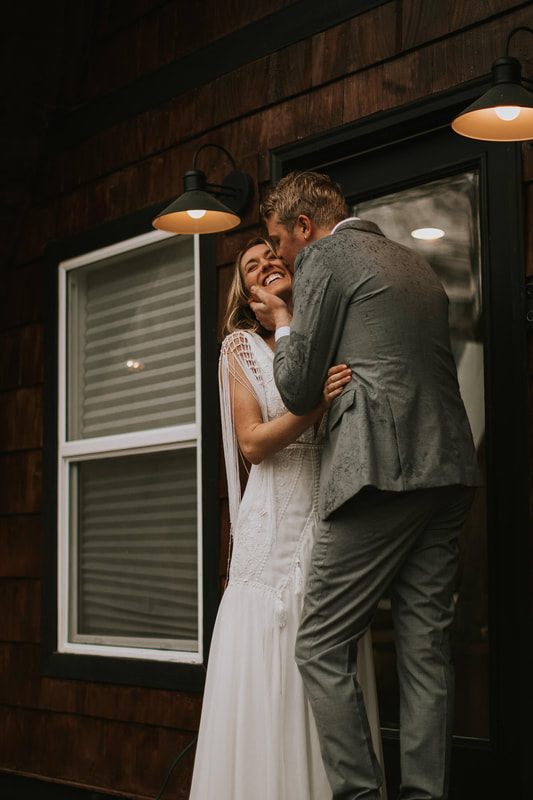 Bride and groom embracing with mountain views in the background