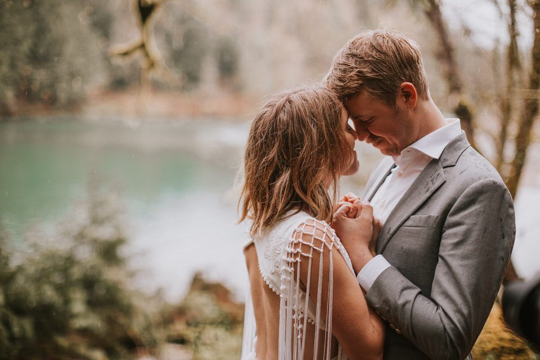 Groom lifting his bride during a joyful moment in the forest