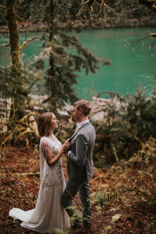 Bride and groom holding hands while walking toward the cabin