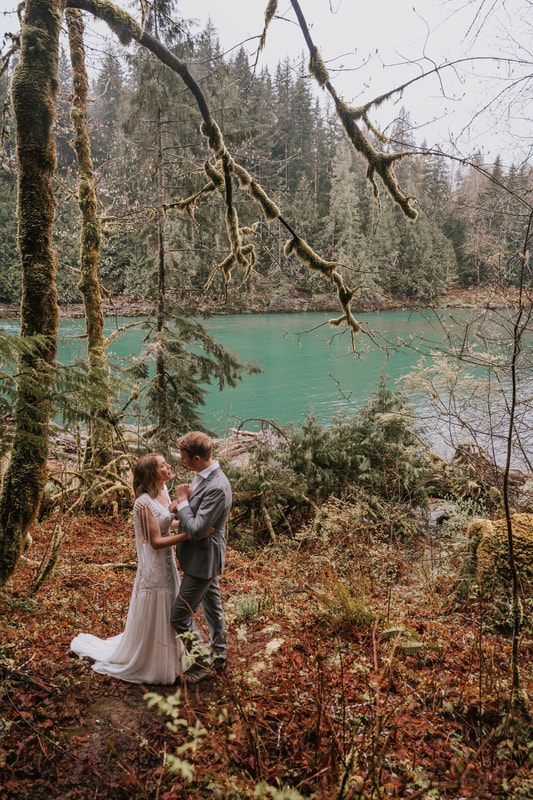 Newlyweds sharing a quiet embrace by the creek