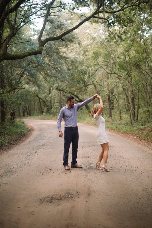 The engaged couple walking along the coastline along the Johns Island coast