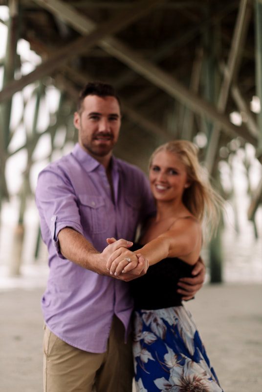 The engaged couple strolling along a rural path along a quiet Lowcountry road