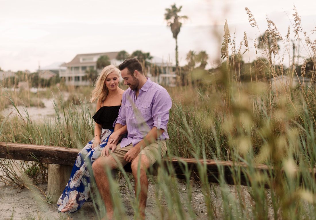 Andrew and Kelly laughing together outdoors beneath Spanish moss near Charleston
