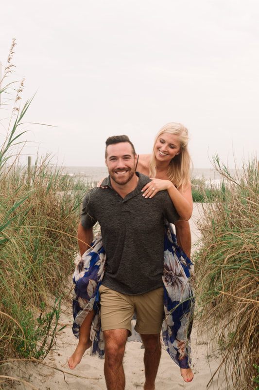 Andrew and Kelly walking along the coastline near the water on Johns Island