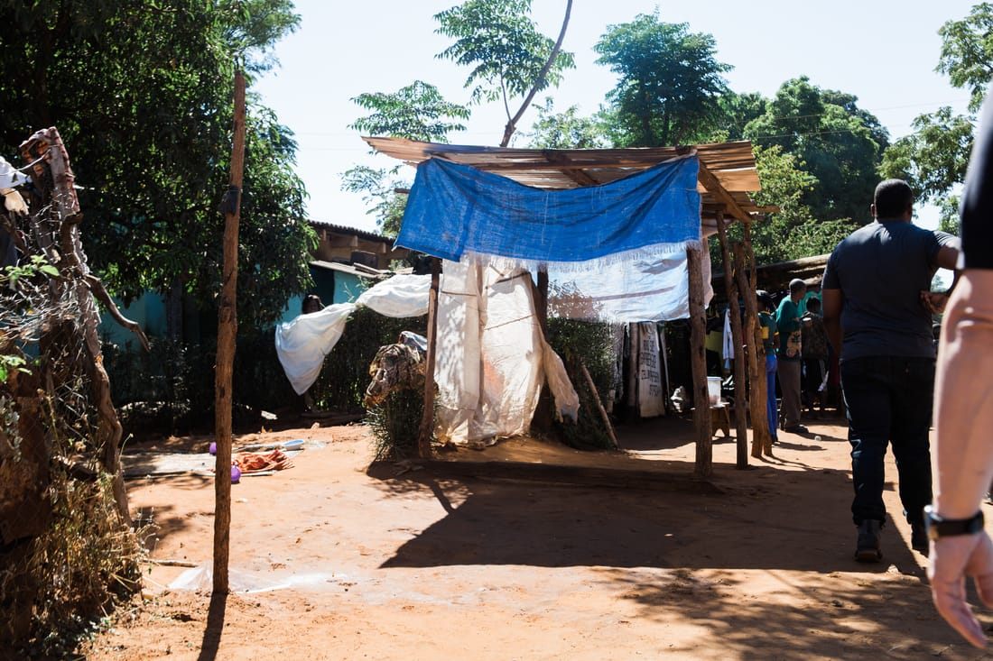 Handwoven baskets and secondhand goods for sale at a Zambian street market