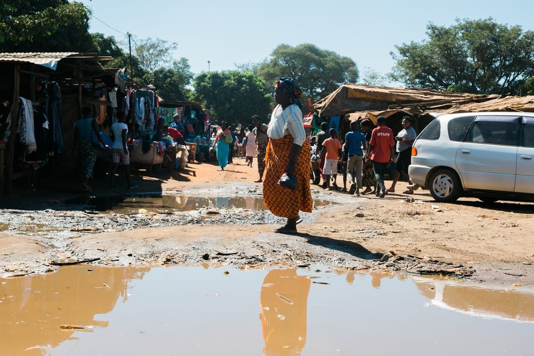 Local shoppers browsing an informal market street in Zambia