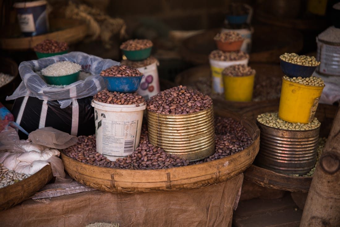 Handwoven baskets and secondhand goods for sale at a Zambian street market