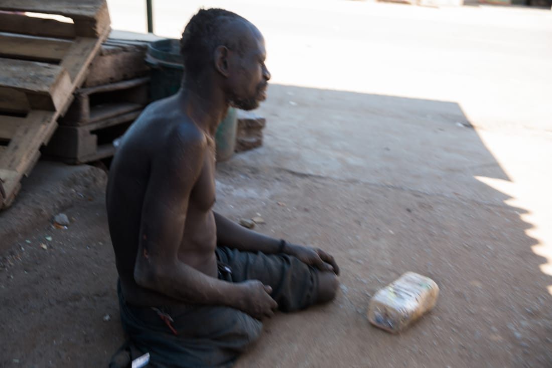 Local shoppers browsing an informal market street in Zambia