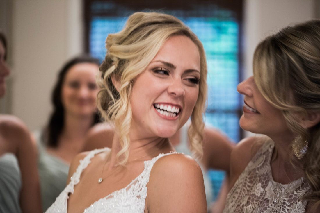 Bride adjusting her veil before walking down the aisle