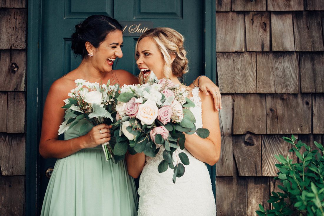 Bridesmaids helping the bride into her gown before the ceremony