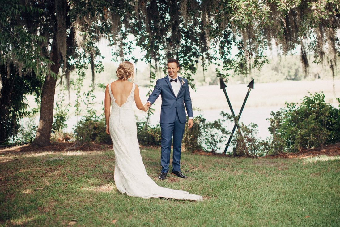 Newlyweds walking hand in hand through the plantation gardens at dusk