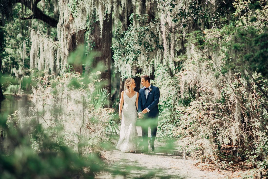 Bride and groom exchanging vows outdoors at Magnolia Plantation