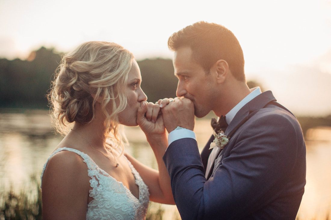 Groom straightening his tie before seeing his bride for the first time