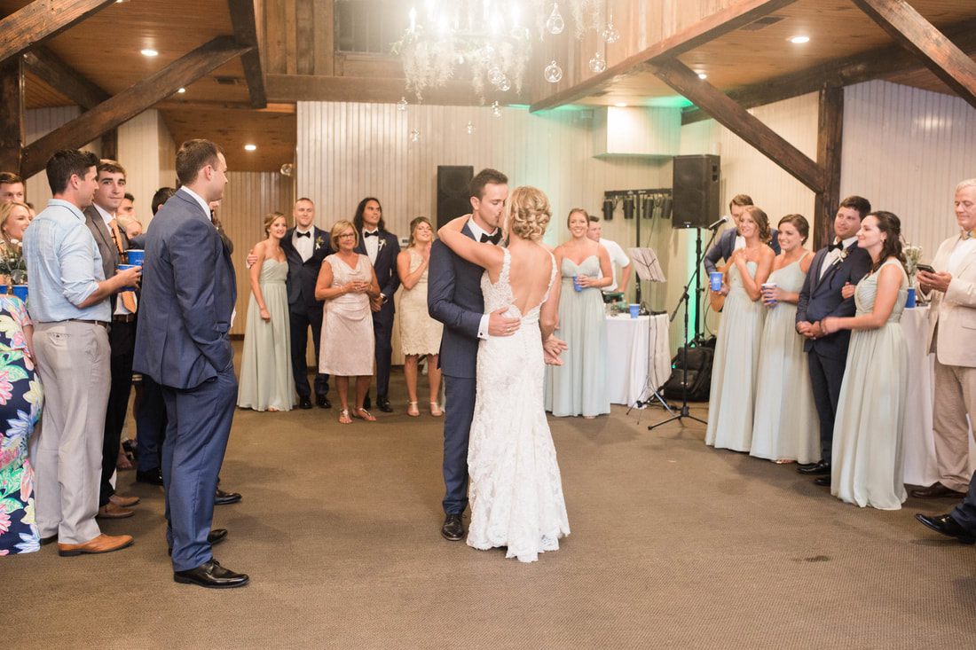 Ashley and Madison sharing a candid laugh during their Charleston wedding at Magnolia Plantation