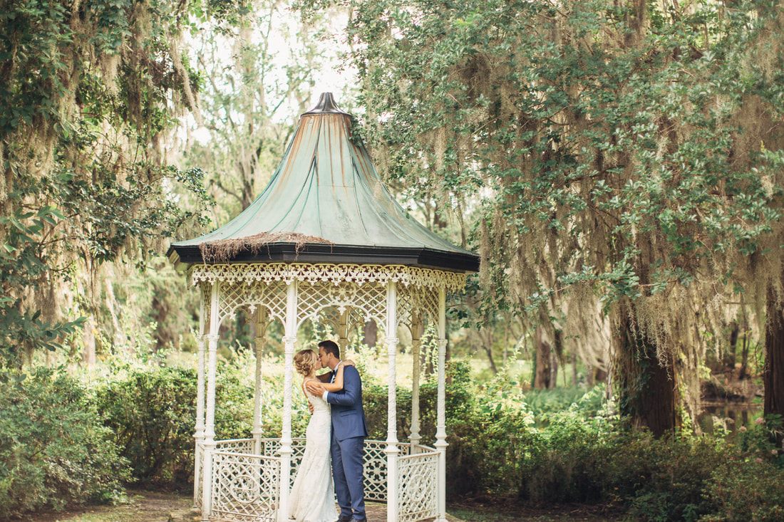 Candid portrait of the newlyweds walking through the Charleston gardens