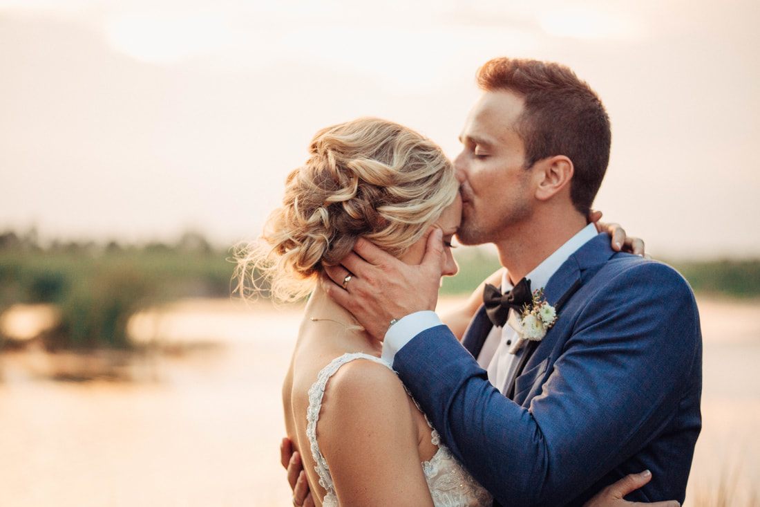 Wedding portrait of Ashley and Madison in front of the plantation house