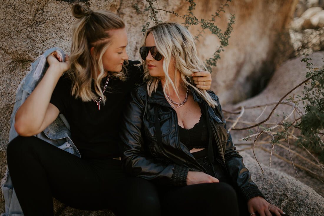 Ciarra and AJ pose together among the rock formations of Joshua Tree National Park.