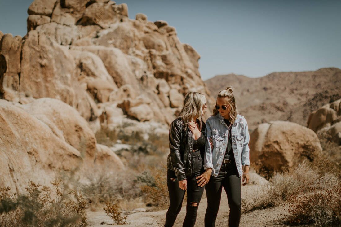 Ciarra and AJ pose against the desert sky in Joshua Tree, California.
