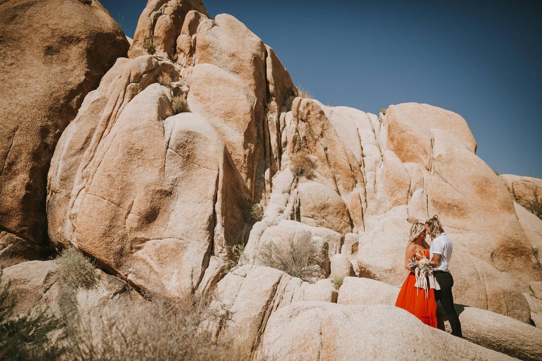 A candid portrait of Ciarra and AJ laughing in the California desert.