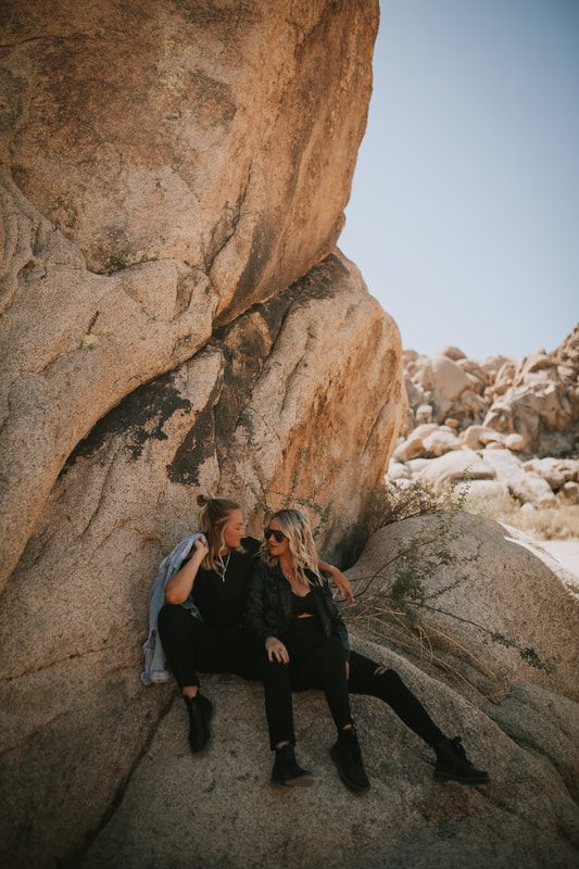 Close-up portrait of Ciarra and AJ smiling in the California desert.