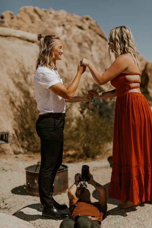Ciarra and AJ pose against the desert sky in Joshua Tree, California.