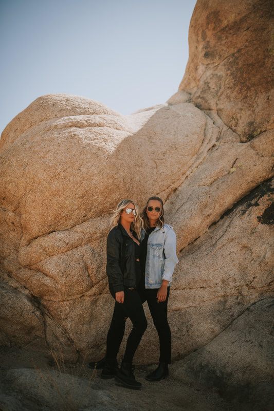 Ciarra and AJ pose together at golden hour in the desert.