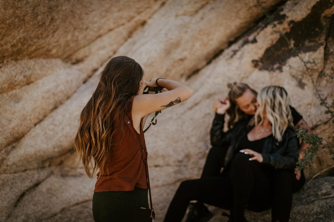 Ciarra and AJ pose together among the rock formations of Joshua Tree National Park.