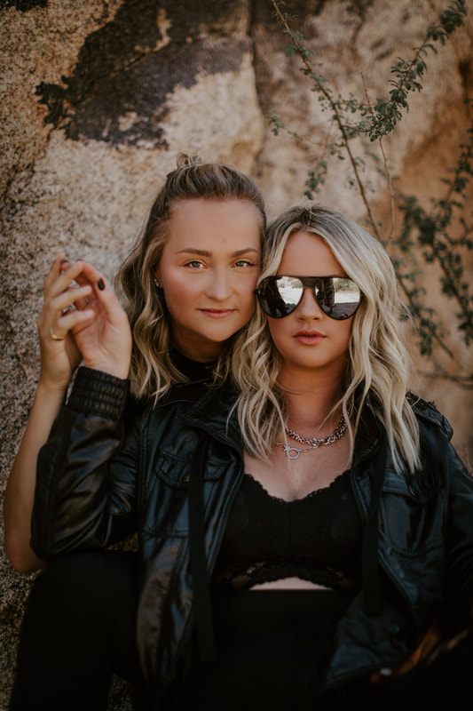 Close-up portrait of Ciarra and AJ smiling in the California desert.