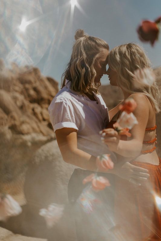 Ciarra and AJ pose against the desert sky in Joshua Tree, California.