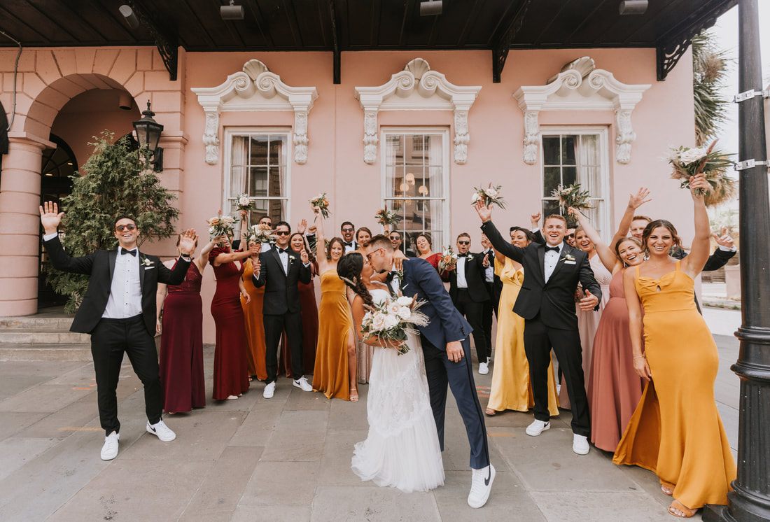 Groomsmen posing together on a historic Charleston street