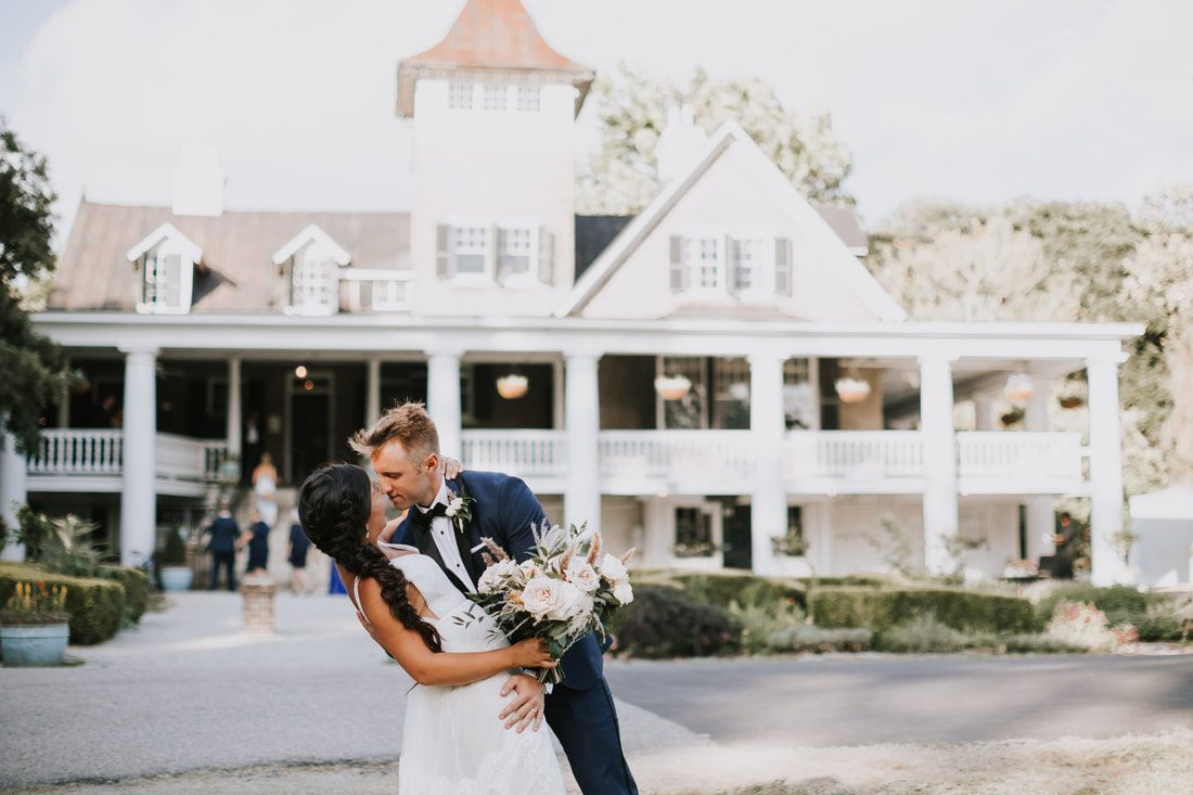 Bride and groom portrait beneath the moss-draped oaks at Magnolia Plantation
